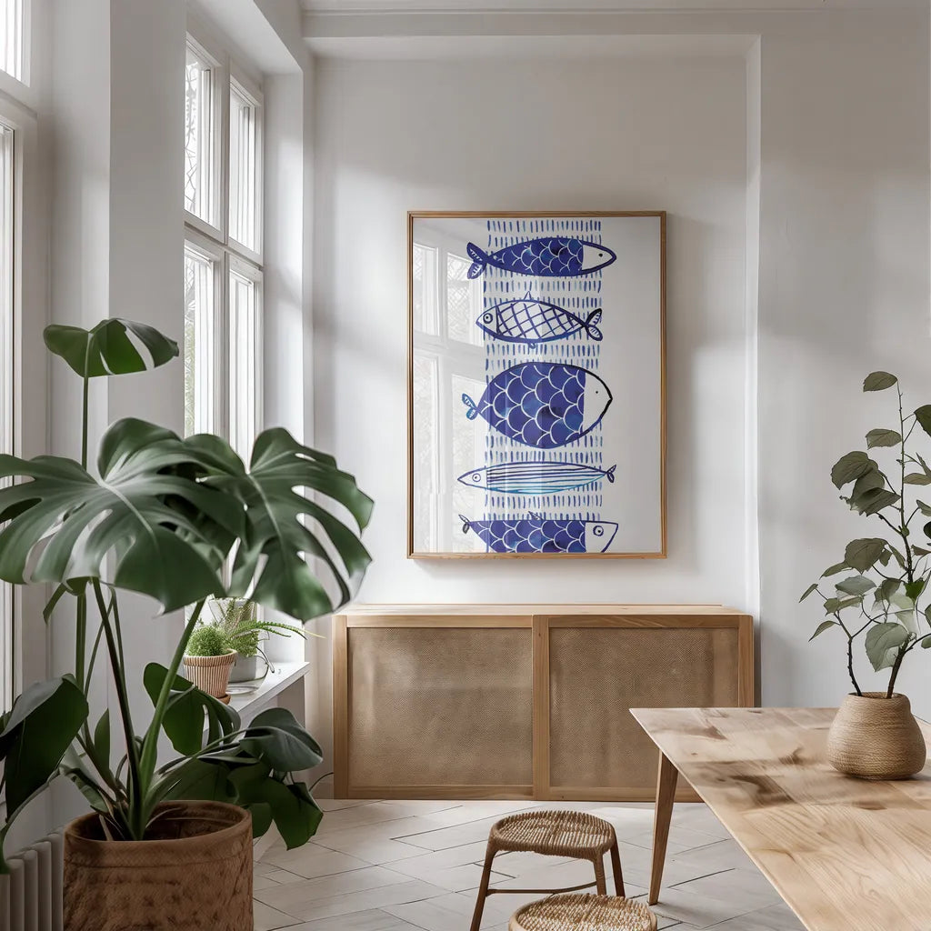 Blue Fish I by Mercedes Lopez Charro. shown as a print in a natural wood frame in a dining room. Available as a archival giclee rolled canvas, fine art paper, or poster print. SKU 77493h.
