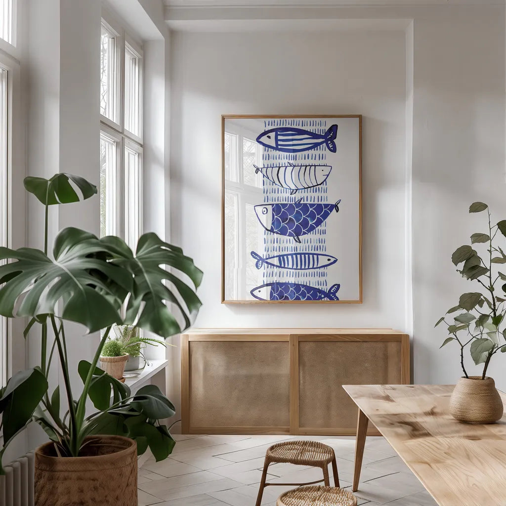 Blue Fish II by Mercedes Lopez Charro. shown as a print in a natural wood frame in a dining room. Available as a archival giclee rolled canvas, fine art paper, or poster print. SKU 77494h.