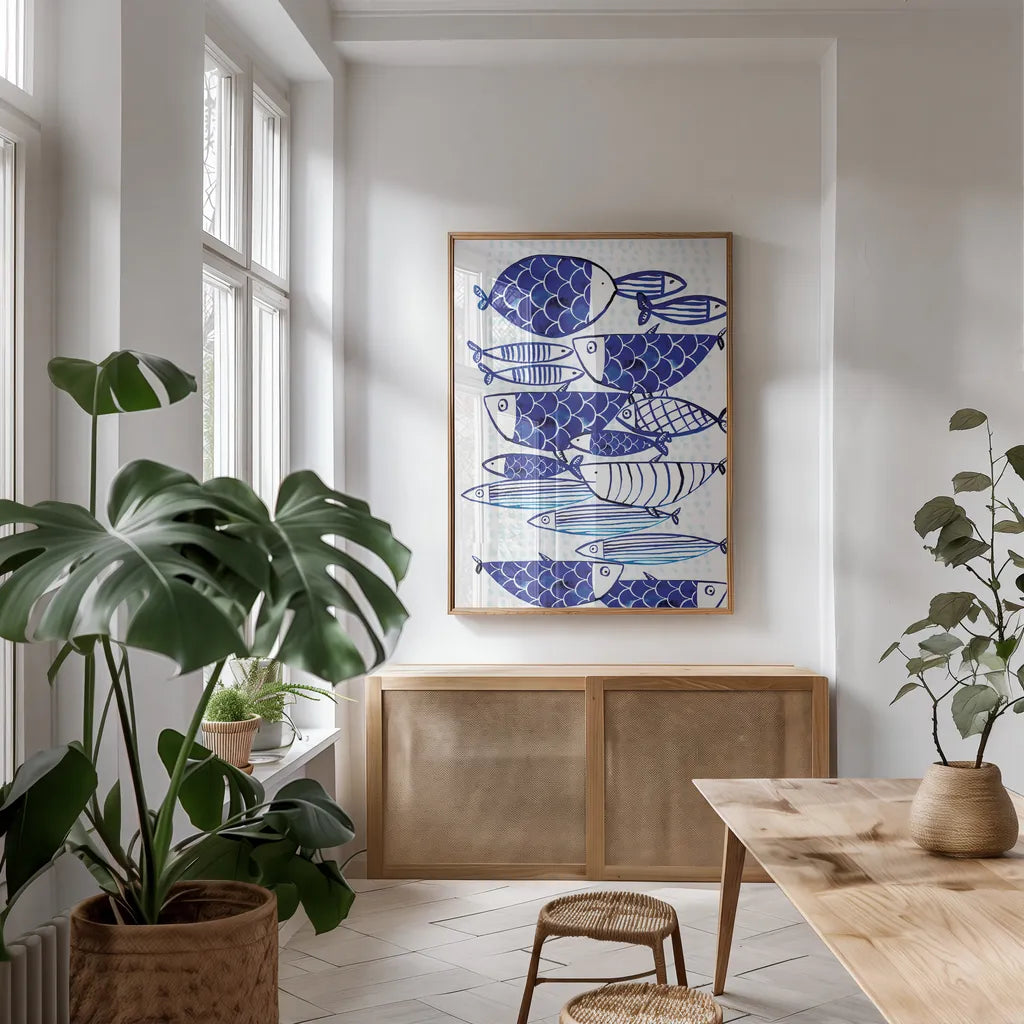 Blue Fish III by Mercedes Lopez Charro. shown as a print in a natural wood frame in a dining room. Available as a archival giclee rolled canvas, fine art paper, or poster print. SKU 77495h.