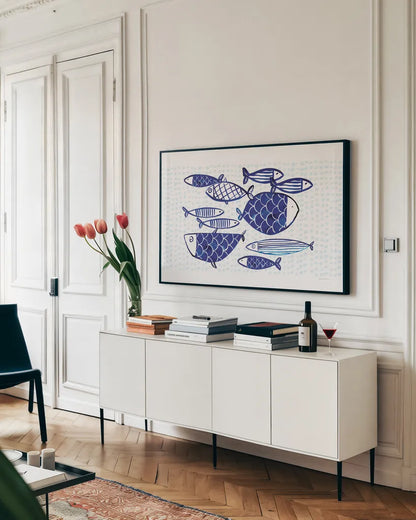 Blue Fish IV by Mercedes Lopez Charro. shown as a framed stretched canvas in a living room above a console. Available as a archival giclee rolled canvas, fine art paper, or poster print. SKU 79252i.