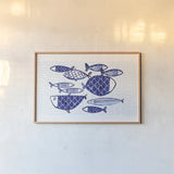 Blue Fish IV by Mercedes Lopez Charro. shown as a paper print in a natural frame. Available as a archival giclee rolled canvas, fine art paper, or poster print. SKU 79252i.