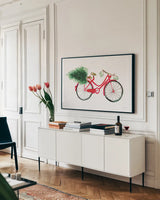 Christmas Delivery I by Mercedes Lopez Charro. shown as a framed stretched canvas in a living room above a console. Available as a archival giclee rolled canvas, fine art paper, or poster print. SKU 71531i.
