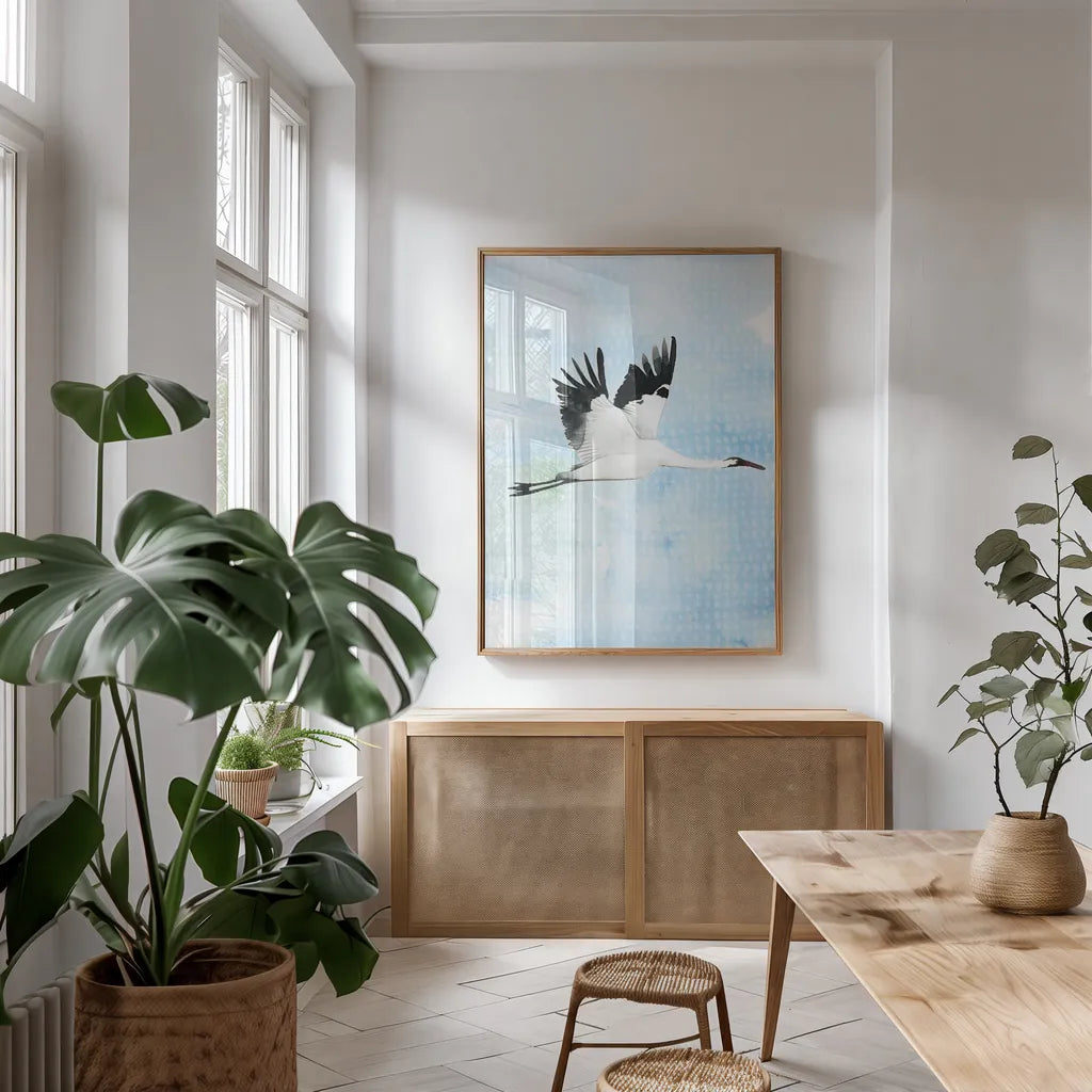 Crane in Flight I by Mercedes Lopez Charro. shown as a print in a natural wood frame in a dining room. Available as a archival giclee rolled canvas, fine art paper, or poster print. SKU 77497h.