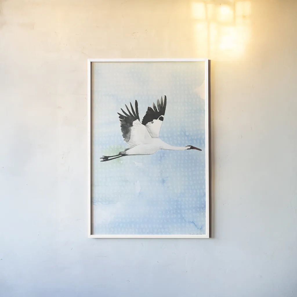 Crane in Flight I by Mercedes Lopez Charro. shown as a paper print in a white frame. Available as a archival giclee rolled canvas, fine art paper, or poster print. SKU 77497h.