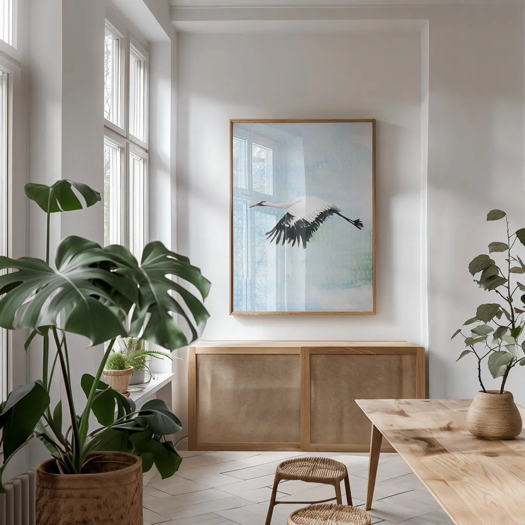 Crane in Flight II by Mercedes Lopez Charro. shown as a print in a natural wood frame in a dining room. Available as a archival giclee rolled canvas, fine art paper, or poster print. SKU 77498h.