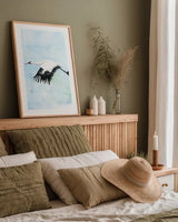 Crane in Flight II by Mercedes Lopez Charro. shown as a paper print in a natural frame. Available as a archival giclee rolled canvas, fine art paper, or poster print. SKU 77498h.