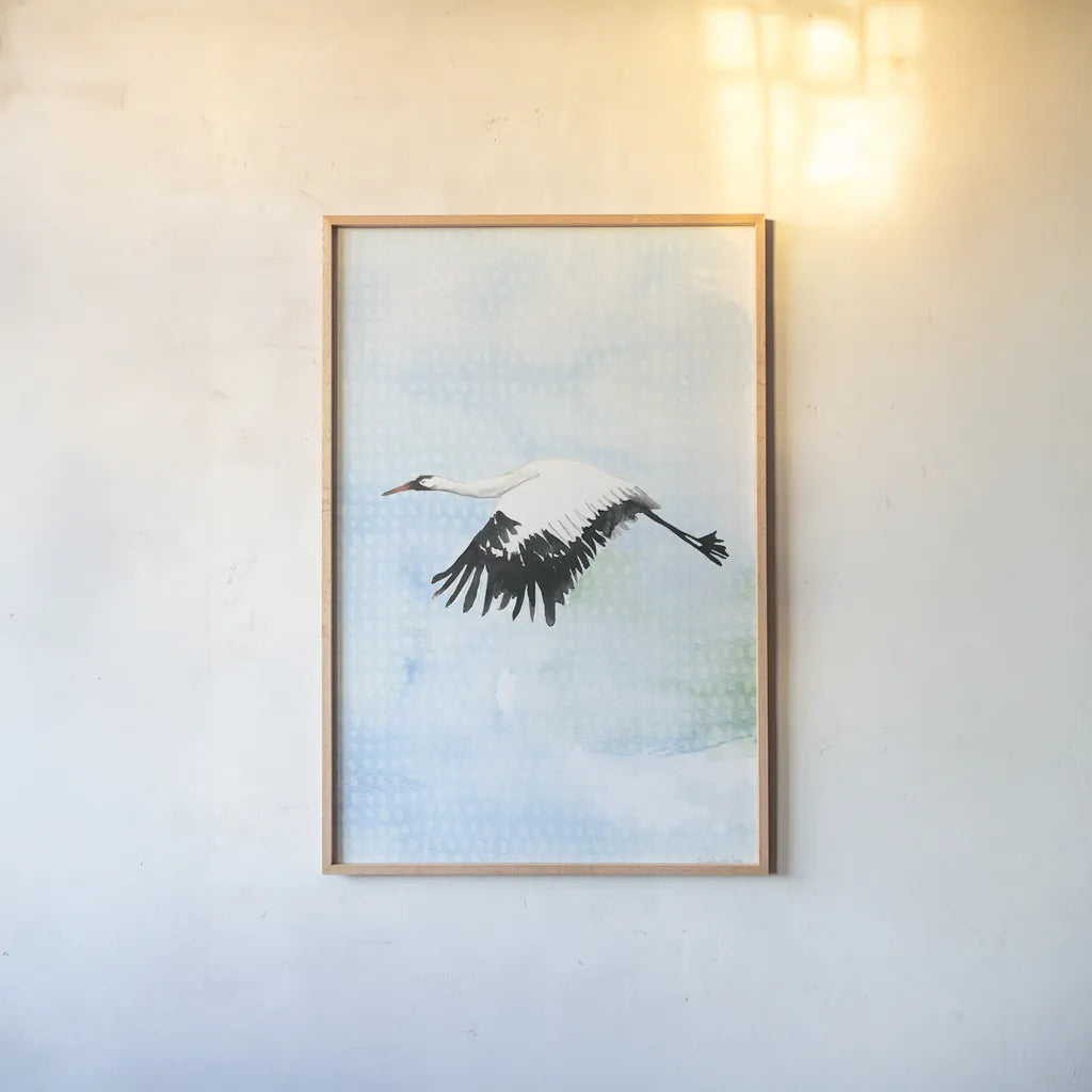 Crane in Flight II by Mercedes Lopez Charro. shown as a paper print in a natural frame. Available as a archival giclee rolled canvas, fine art paper, or poster print. SKU 77498h.