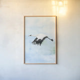 Crane in Flight II by Mercedes Lopez Charro. shown as a paper print in a natural frame. Available as a archival giclee rolled canvas, fine art paper, or poster print. SKU 77498h.