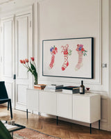 Decked Out Stockings by Mercedes Lopez Charro. shown as a framed stretched canvas in a living room above a console. Available as a archival giclee rolled canvas, fine art paper, or poster print. SKU 77101i.