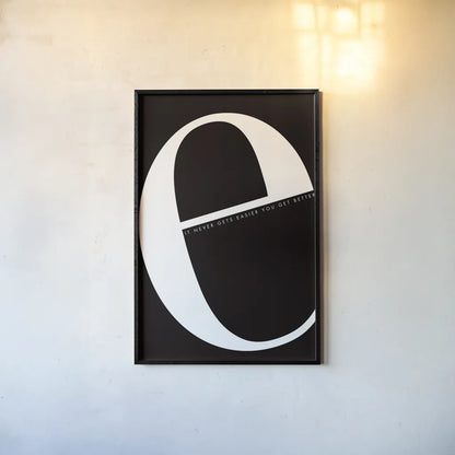 E is for Easier by Mercedes Lopez Charro. shown as a paper print in a black flame. Available as a archival giclee rolled canvas, fine art paper, or poster print. SKU 64138h.