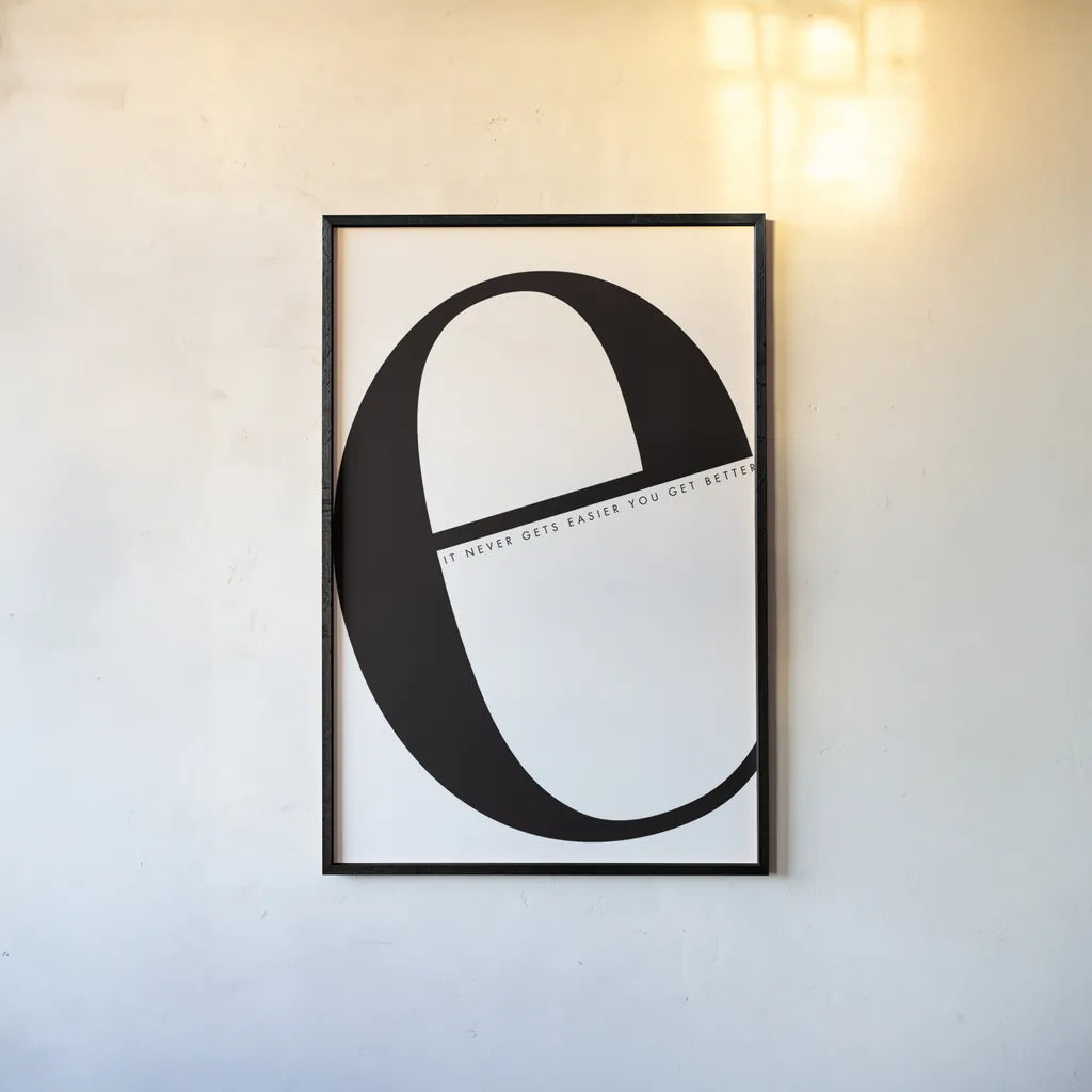 E is for Easier on White by Mercedes Lopez Charro. shown as a paper print in a black flame. Available as a archival giclee rolled canvas, fine art paper, or poster print. SKU 64145h.