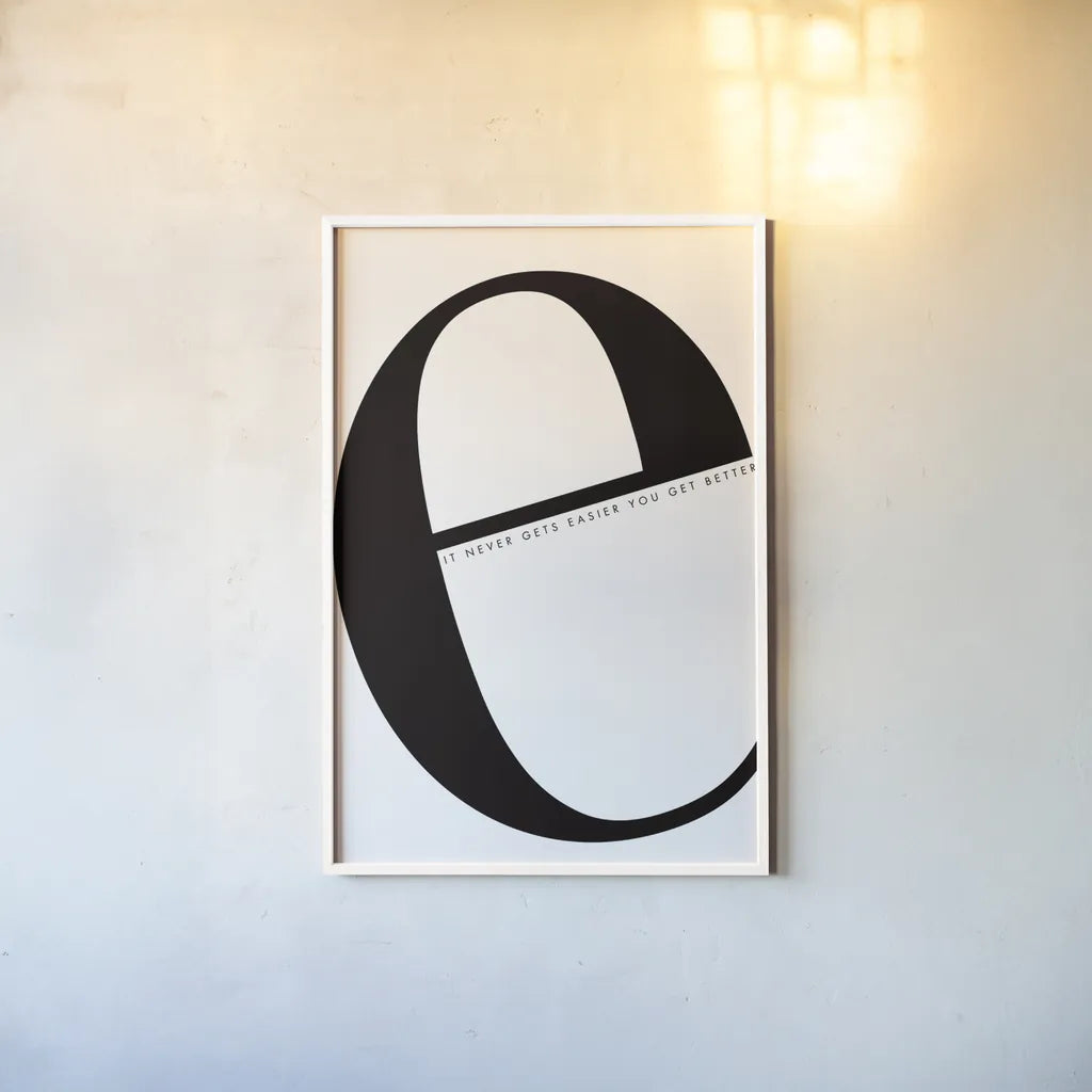 E is for Easier on White by Mercedes Lopez Charro. shown as a paper print in a white frame. Available as a archival giclee rolled canvas, fine art paper, or poster print. SKU 64145h.