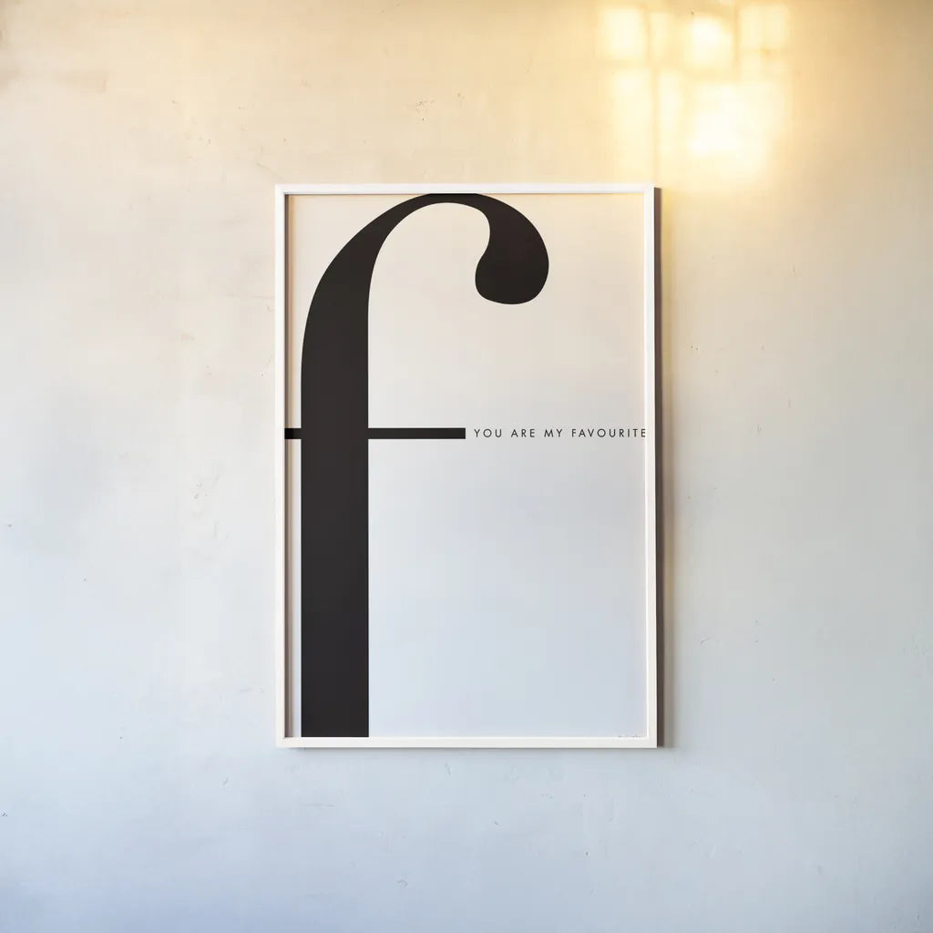 F is for favorite on White by Mercedes Lopez Charro. shown as a paper print in a white frame. Available as a archival giclee rolled canvas, fine art paper, or poster print. SKU 64146h.