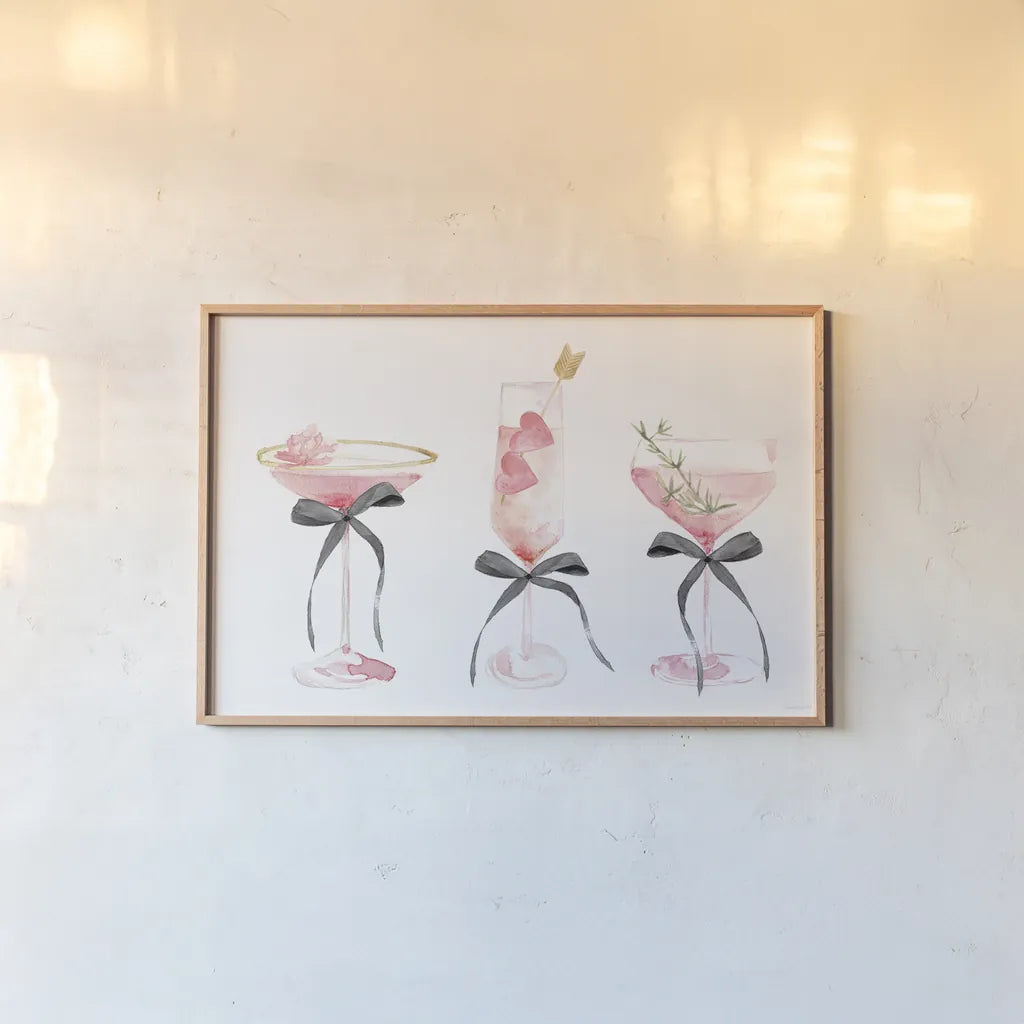 Flirty Champagne III Black Bows by Mercedes Lopez Charro. shown as a paper print in a natural frame. Available as a archival giclee rolled canvas, fine art paper, or poster print. SKU 96871i.