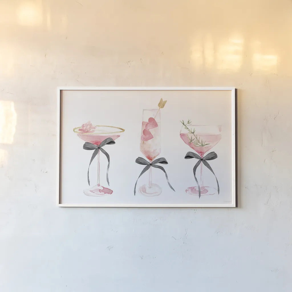 Flirty Champagne III Black Bows by Mercedes Lopez Charro. shown as a paper print in a white frame. Available as a archival giclee rolled canvas, fine art paper, or poster print. SKU 96871i.