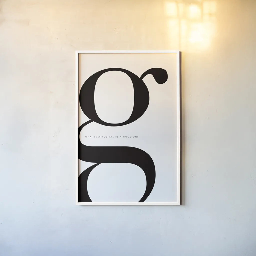 G is for Good on White by Mercedes Lopez Charro. shown as a paper print in a white frame. Available as a archival giclee rolled canvas, fine art paper, or poster print. SKU 64147h.
