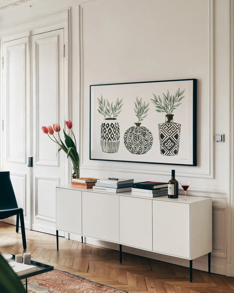 Geometric Vases I Green by Mercedes Lopez Charro. shown as a framed stretched canvas in a living room above a console. Available as a archival giclee rolled canvas, fine art paper, or poster print. SKU 66484i.