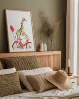 Giraffe Joy Ride I by Mercedes Lopez Charro. shown as a paper print in a natural frame. Available as a archival giclee rolled canvas, fine art paper, or poster print. SKU 73181h.