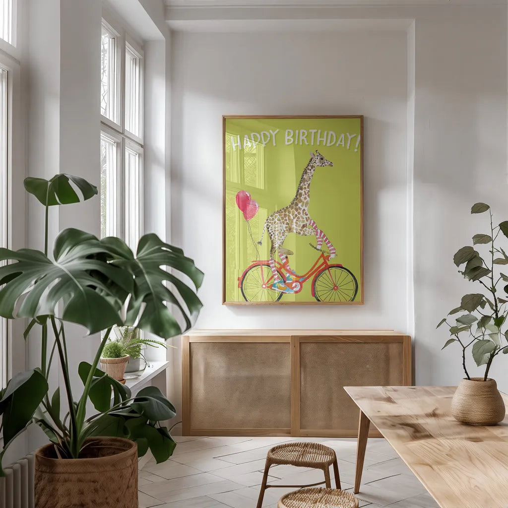 Giraffe Joy Ride I Birthday by Mercedes Lopez Charro. shown as a print in a natural wood frame in a dining room. Available as a archival giclee rolled canvas, fine art paper, or poster print. SKU 78198h.