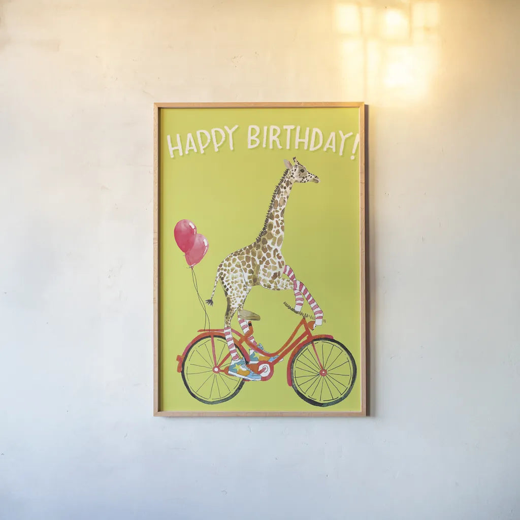 Giraffe Joy Ride I Birthday by Mercedes Lopez Charro. shown as a paper print in a natural frame. Available as a archival giclee rolled canvas, fine art paper, or poster print. SKU 78198h.