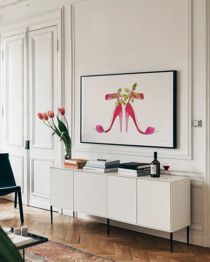 Holiday Stiletto Pair by Mercedes Lopez Charro. shown as a framed stretched canvas in a living room above a console. Available as a archival giclee rolled canvas, fine art paper, or poster print. SKU 67982i.