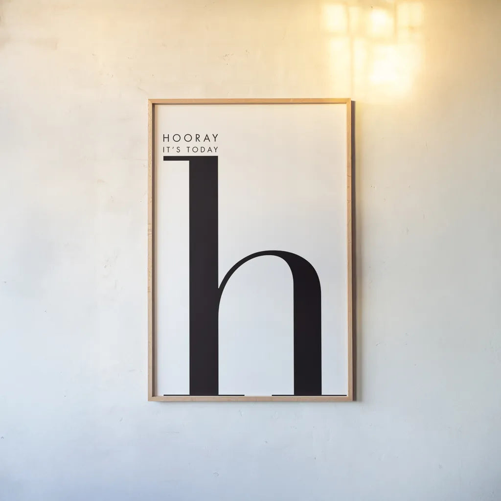Hooray for H on White by Mercedes Lopez Charro. shown as a paper print in a natural frame. Available as a archival giclee rolled canvas, fine art paper, or poster print. SKU 64149h.