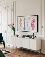Laguna Surfboards I by Mercedes Lopez Charro. shown as a framed stretched canvas in a living room above a console. Available as a archival giclee rolled canvas, fine art paper, or poster print. SKU 82213i.