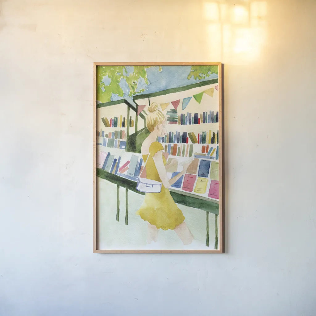 Never Enough Books I by Mercedes Lopez Charro. shown as a paper print in a natural frame. Available as a archival giclee rolled canvas, fine art paper, or poster print. SKU 98644h.