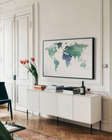 Passport to the World Blue by Mercedes Lopez Charro. shown as a framed stretched canvas in a living room above a console. Available as a archival giclee rolled canvas, fine art paper, or poster print. SKU 71325i.