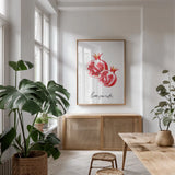 Pomegranates by Mercedes Lopez Charro. shown as a print in a natural wood frame in a dining room. Available as a archival giclee rolled canvas, fine art paper, or poster print. SKU 67134h.