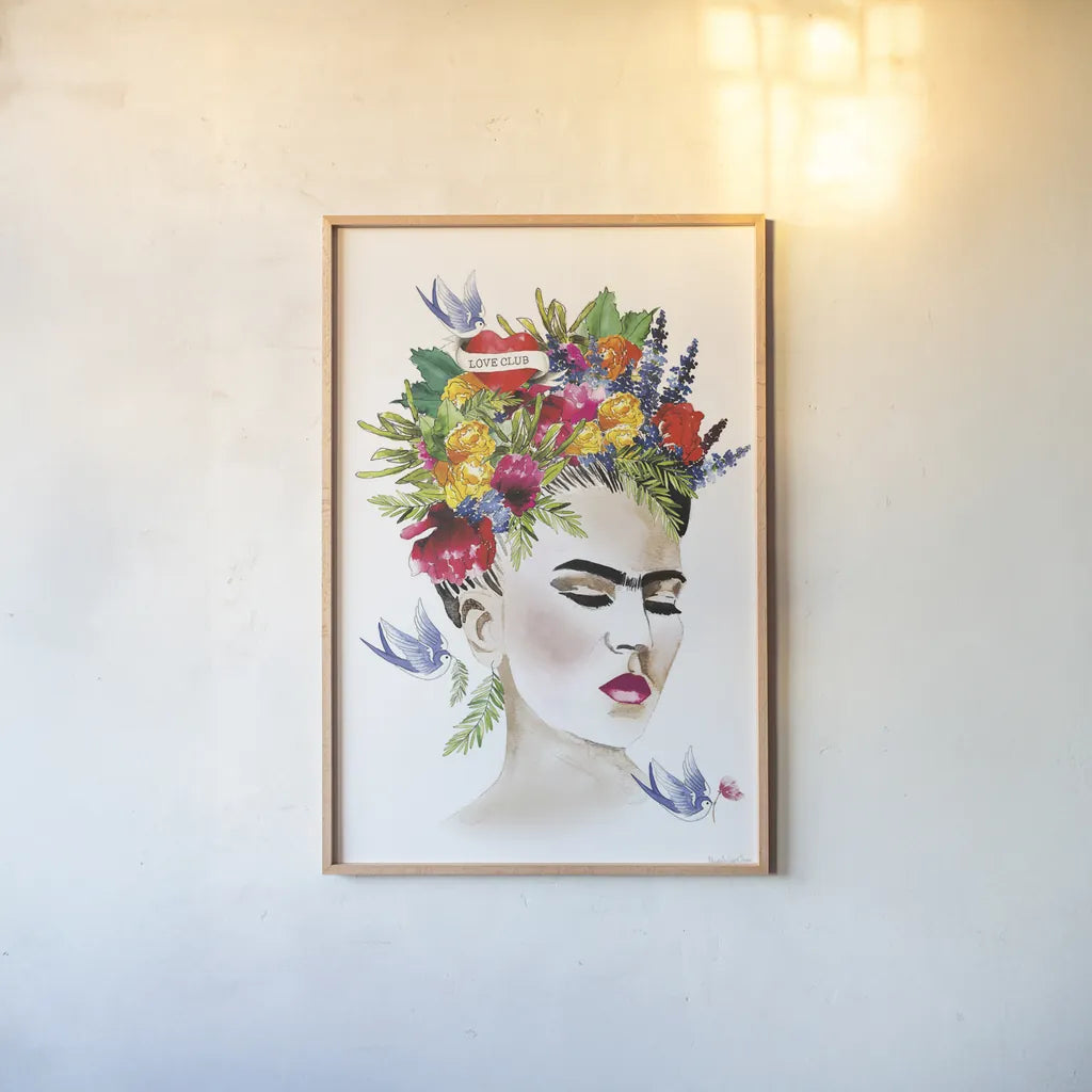 She is Frida by Mercedes Lopez Charro. shown as a paper print in a natural frame. Available as a archival giclee rolled canvas, fine art paper, or poster print. SKU 68092h.