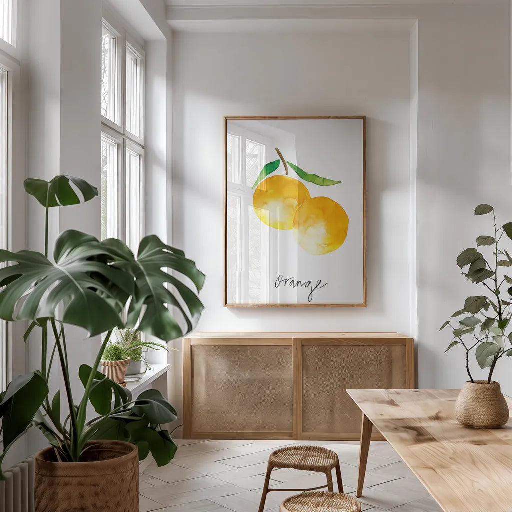 Single Orange by Mercedes Lopez Charro. shown as a print in a natural wood frame in a dining room. Available as a archival giclee rolled canvas, fine art paper, or poster print. SKU 67135h.