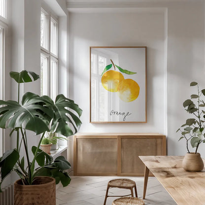 Single Orange by Mercedes Lopez Charro. shown as a print in a natural wood frame in a dining room. Available as a archival giclee rolled canvas, fine art paper, or poster print. SKU 67135h.