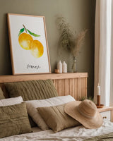 Single Orange by Mercedes Lopez Charro. shown as a paper print in a natural frame. Available as a archival giclee rolled canvas, fine art paper, or poster print. SKU 67135h.