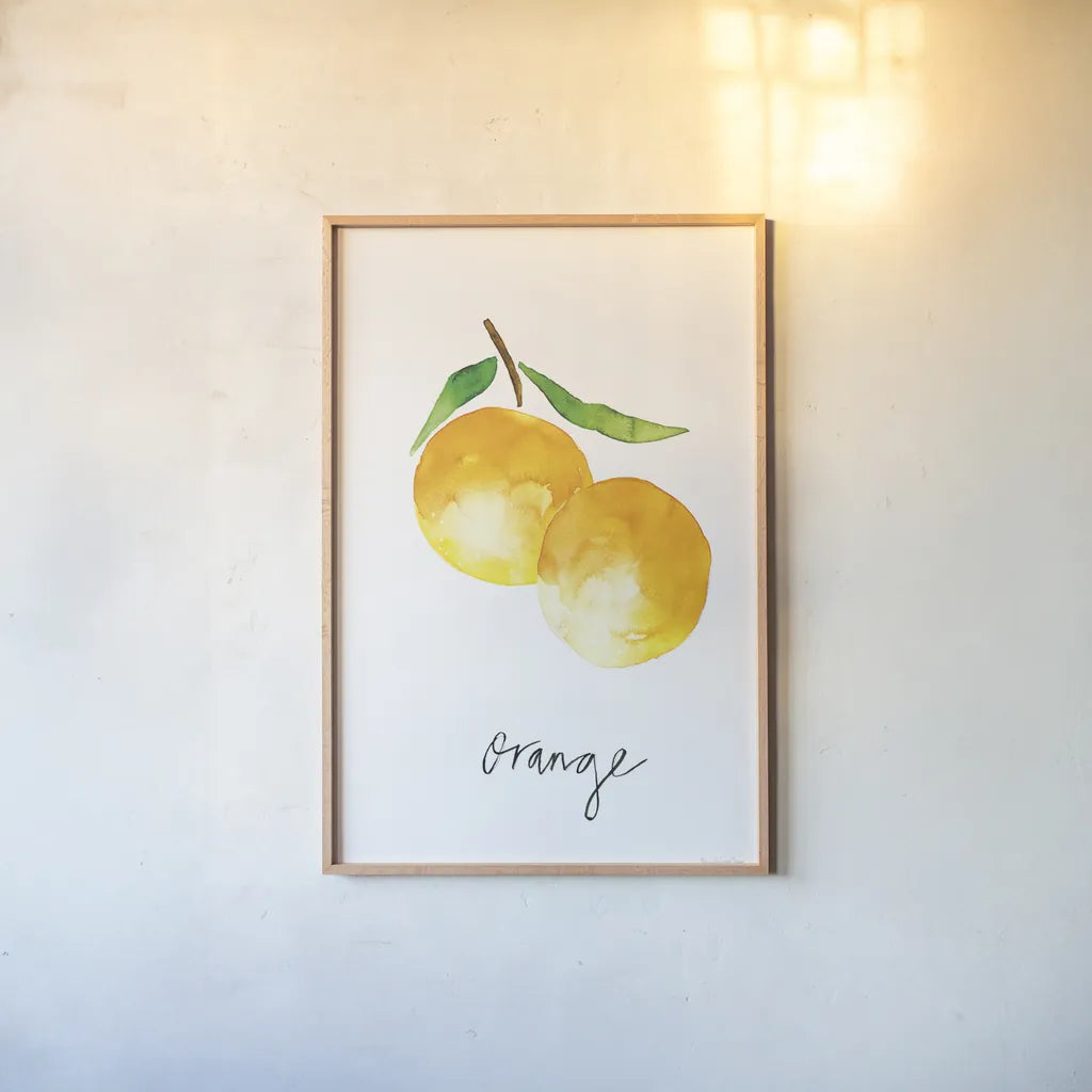 Single Orange by Mercedes Lopez Charro. shown as a paper print in a natural frame. Available as a archival giclee rolled canvas, fine art paper, or poster print. SKU 67135h.
