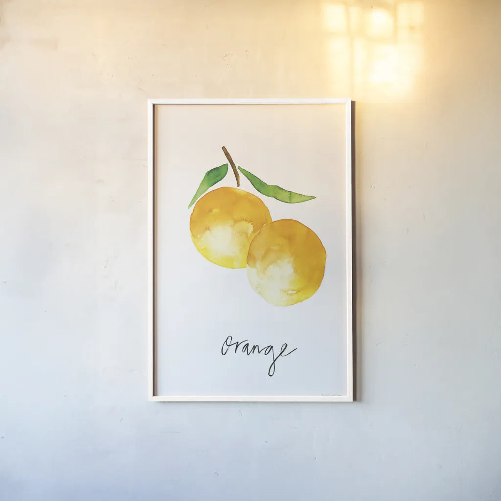 Single Orange by Mercedes Lopez Charro. shown as a paper print in a white frame. Available as a archival giclee rolled canvas, fine art paper, or poster print. SKU 67135h.