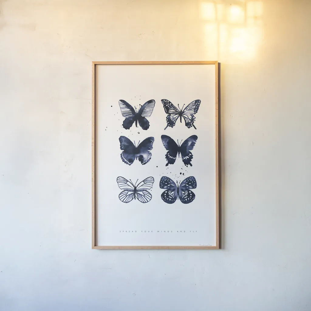 Six Inky Butterflies Blue by Mercedes Lopez Charro. shown as a paper print in a natural frame. Available as a archival giclee rolled canvas, fine art paper, or poster print. SKU 68239h.