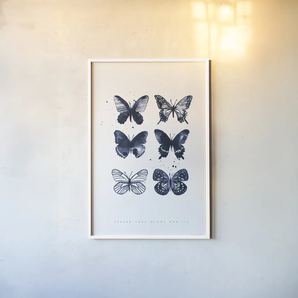 Six Inky Butterflies Blue by Mercedes Lopez Charro. shown as a paper print in a white frame. Available as a archival giclee rolled canvas, fine art paper, or poster print. SKU 68239h.