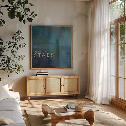 Stars Gold by Mercedes Lopez Charro. Shown in a natural wood frame in a cozy modern living room. Available as an archival giclee rolled canvas, fine art paper, or poster print. SKU 74524a.