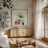 Weekend Plants IV by Mercedes Lopez Charro. Shown in a natural wood frame in a cozy modern living room. Available as an archival giclee rolled canvas, fine art paper, or poster print. SKU 79536a.