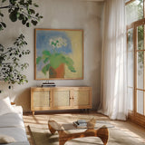Cream Primula by Michael Clark. Shown in a natural wood frame in a cozy modern living room. Available as an archival giclee rolled canvas, fine art paper, or poster print. SKU 8724a.