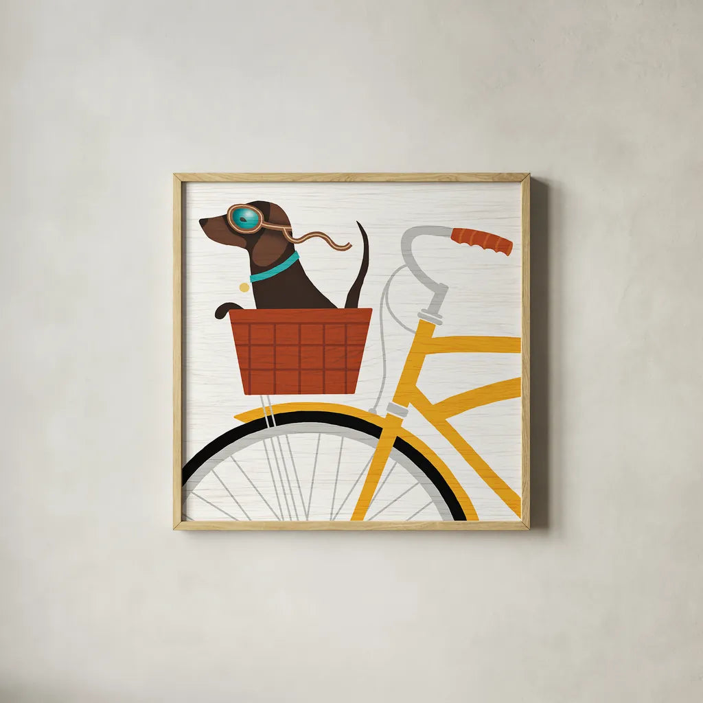 Beach Bums Dachshund Bicycle I by Michael Mullan. Shown in a natural wood glass frame for a timeless modern aesthetic. Available as an archival giclee rolled canvas, fine art paper, or poster print. SKU 23291a.