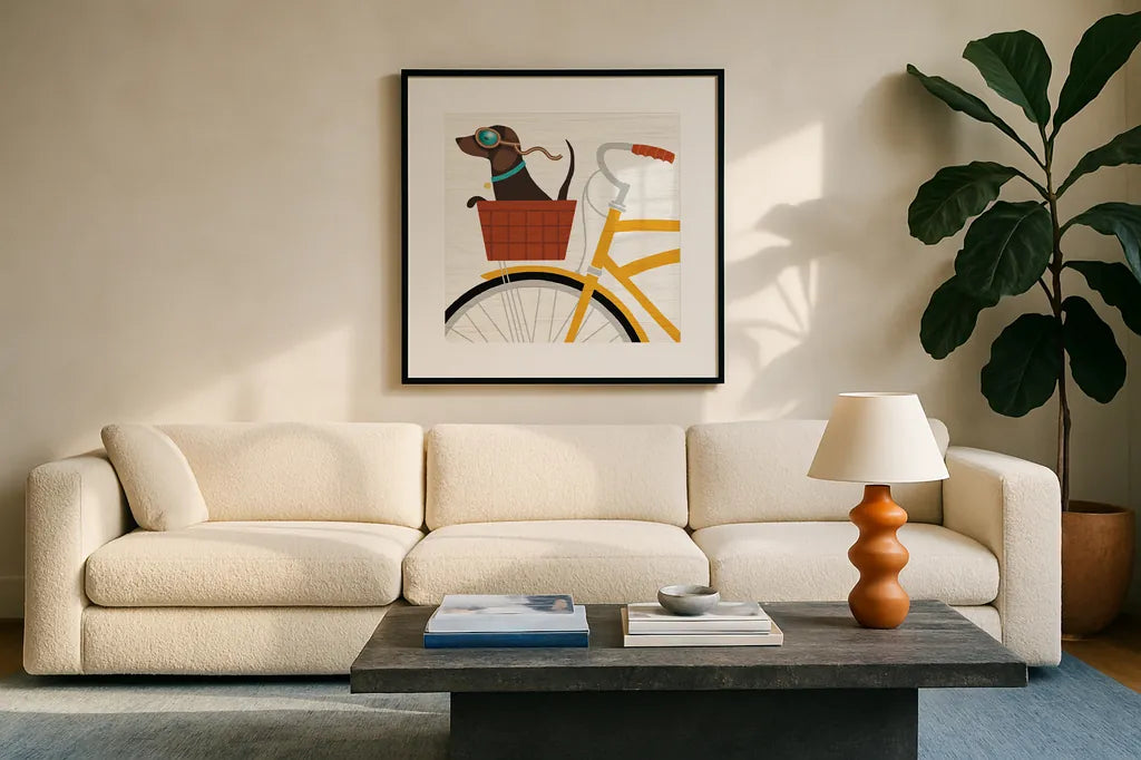 Beach Bums Dachshund Bicycle I by Michael Mullan. Displayed in a glass frame with matte in a clean modern living room. Available as an archival giclee rolled canvas, fine art paper, or poster print. SKU 23291a.