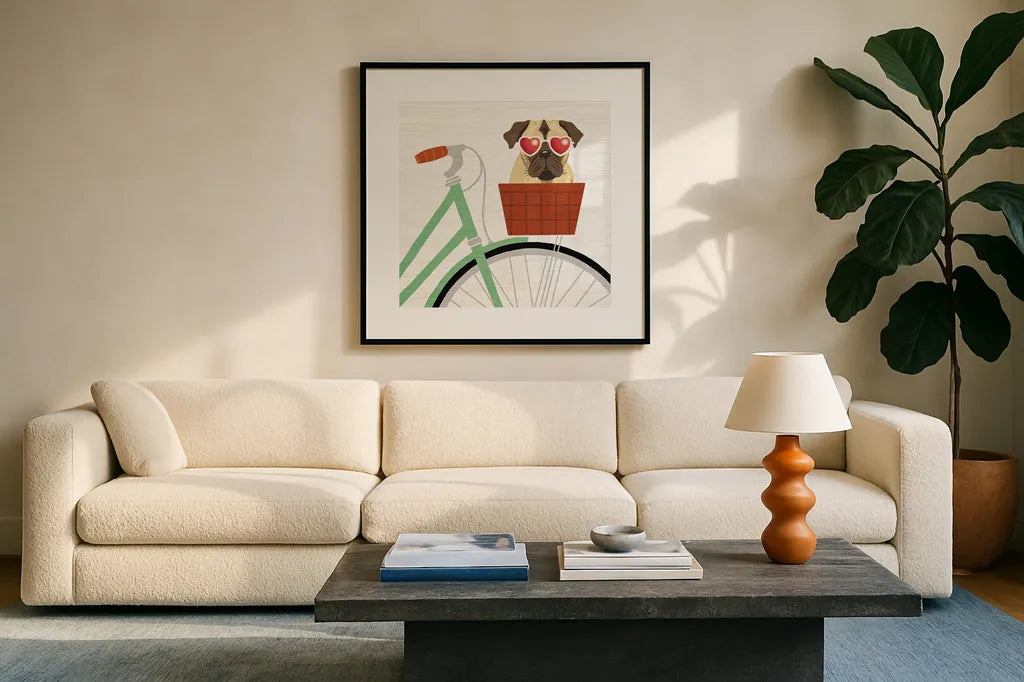 Beach Bums Pug Bicycle I by Michael Mullan. Displayed in a glass frame with matte in a clean modern living room. Available as an archival giclee rolled canvas, fine art paper, or poster print. SKU 23280a.