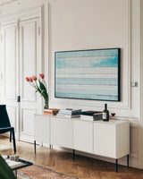 Beachscape IX blue by Michael Mullan. shown as a framed stretched canvas in a living room above a console. Available as a archival giclee rolled canvas, fine art paper, or poster print. SKU 44984i.