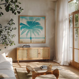 Beachscape Palms II by Michael Mullan. Shown in a natural wood frame in a cozy modern living room. Available as an archival giclee rolled canvas, fine art paper, or poster print. SKU 23153a.