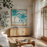 Beachscape Palms III by Michael Mullan. Shown in a natural wood frame in a cozy modern living room. Available as an archival giclee rolled canvas, fine art paper, or poster print. SKU 23154a.
