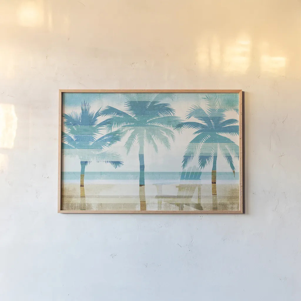 Beachscape Palms with chair by Michael Mullan. shown as a paper print in a natural frame. Available as a archival giclee rolled canvas, fine art paper, or poster print. SKU 44889i.