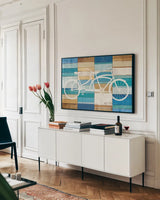 Beachscape Tandem Cruiser by Michael Mullan. shown as a framed stretched canvas in a living room above a console. Available as a archival giclee rolled canvas, fine art paper, or poster print. SKU 23116i.