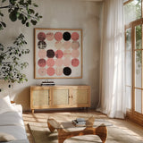 Dots II Square II Pink Black by Michael Mullan. Shown in a natural wood frame in a cozy modern living room. Available as an archival giclee rolled canvas, fine art paper, or poster print. SKU 53753a.